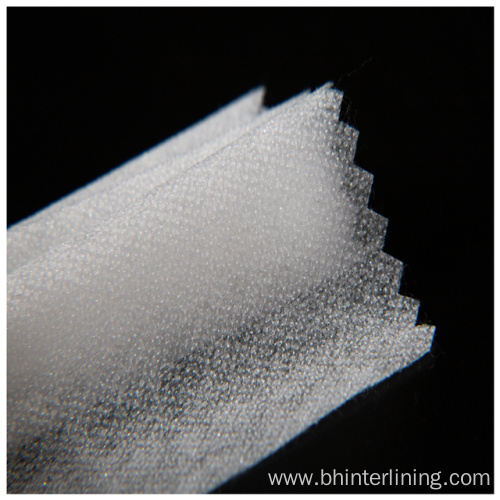 Soft and smooth feeling fusible nonwoven interlining fabric